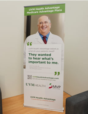 UVM Health pull-up banner in an office setting